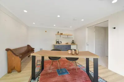 a dining room with a table and a couch at The Bayside Cottage by EMR Vacation Rentals in North Saanich