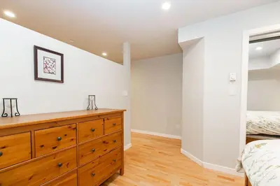 a bedroom with a wooden dresser and a bed at Lovely 1 Bedroom Suite Near Town in Victoria