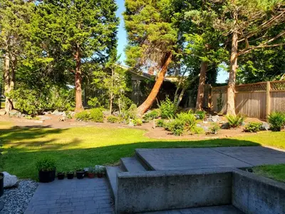 a garden with a stone patio and a fence at Lovely 1 Bedroom Suite Near Town in Victoria