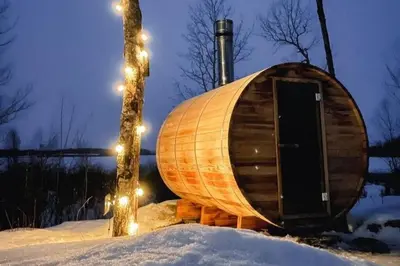 a wooden tub sitting next to a tree in the snow at Refuge Bay's Ignis Dome - Luxury Off Grid Escape in Cherhill
