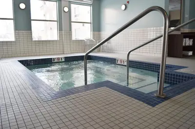 a swimming pool in a building with ailed floor at Holiday Inn Express Golden-Kicking Horse by IHG in Golden