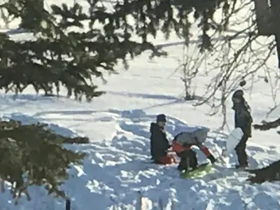 a group of people sitting in the snow at Rolling Hills Country Resort Bed and Breakfast in Three Hills