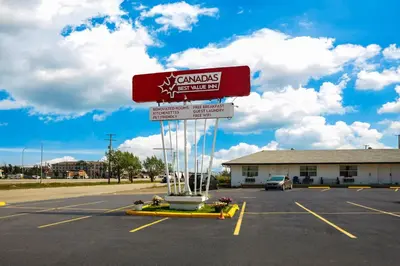 a gas station sign in a parking lot at Canadas Best Value Inn Fort St John in Fort Saint John
