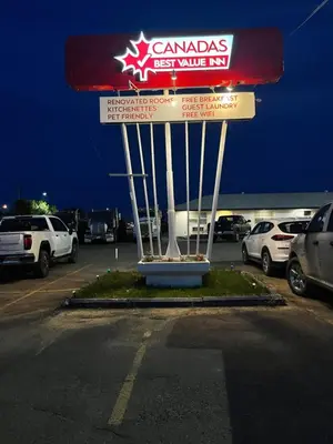 a canadian gas station sign in a parking lot at Canadas Best Value Inn Fort St John in Fort Saint John