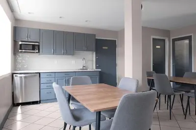 a kitchen with a wooden table and chairs at Copper Mountain Inn and Suites in Princeton