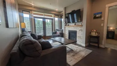 a living room with a couch and a fireplace at Echo Landing #37 condo in Sun Peaks