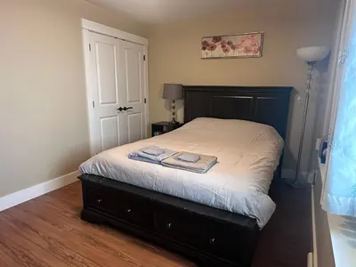a bedroom with a bed with two towels on it at Separate entry sweet home in Victoria