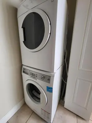 a washer and dryer sitting next to a door at Moonlight Suite in Vancouver