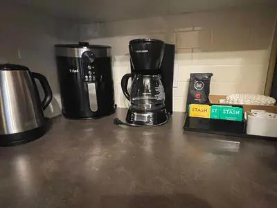 a coffeemaker and a coffee maker on a counter at Spacious King Bed with Pool & Hot Tubs in Canmore