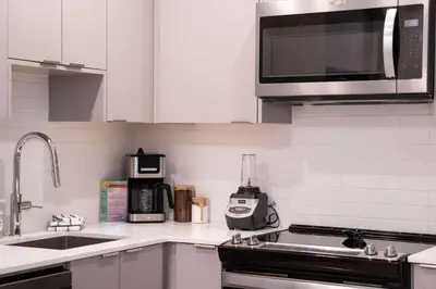 a kitchen with a sink and a microwave at Northern Exposure by Revelstoke Vacations in Revelstoke