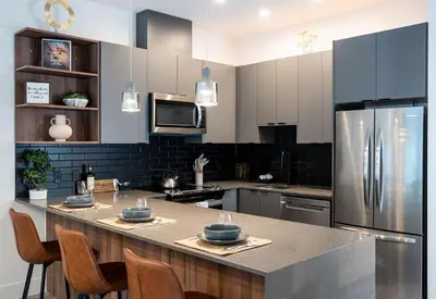 a kitchen with a large kitchen island with a refrigerator at Summit Place - Condo With Mountain Views in Revelstoke