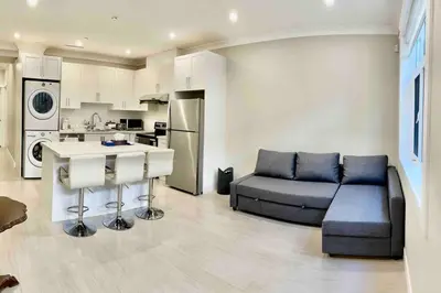 a large living room with a couch and a kitchen at \u6e29\u897f\u6c11\u5bbf Vancouver West Quiet Home in Vancouver