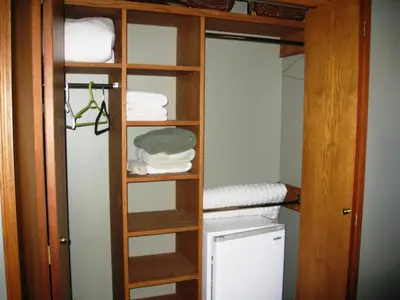 a closet with a bunk bed with towels at McDougall Lane Bed & Breakfast in Drumheller