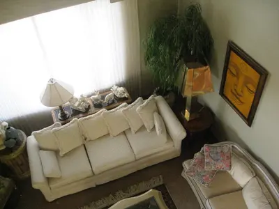 a living room with a white couch and a window at McDougall Lane Bed & Breakfast in Drumheller