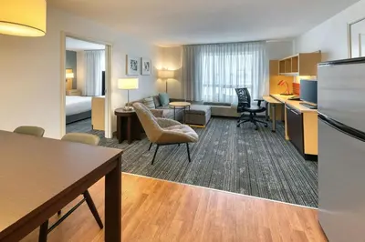 a hotel room with a kitchen and a living room at TownePlace Suites by Marriott Red Deer in Red Deer