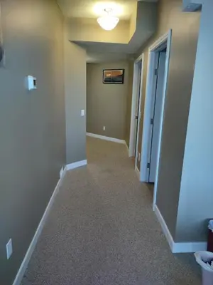 an empty hallway of a home with a hallway at Spacious One Bedroom Walkout Basement Suite in Calgary
