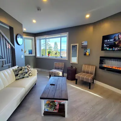 a living room with a couch and a tv at Garden House Near Heritage Park-Coliseum -HWY 1-Fishing-Cultus Lake in Chilliwack
