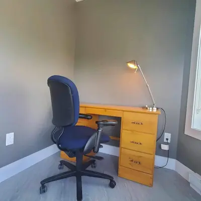 an office with a chair and a desk with a lamp at Garden House Near Heritage Park-Coliseum -HWY 1-Fishing-Cultus Lake in Chilliwack