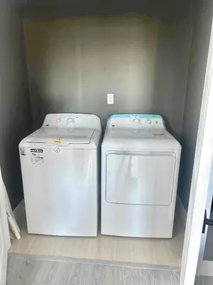 two washing machines sitting next to each other in a laundry room at Garden House Near Heritage Park-Coliseum -HWY 1-Fishing-Cultus Lake in Chilliwack