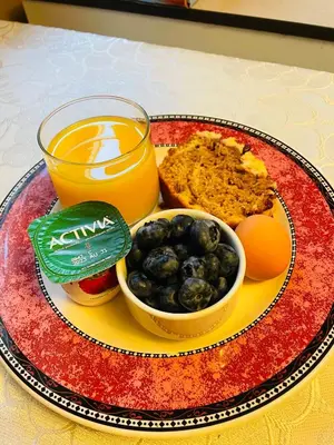 a plate of food with a glass of orange juice and fruit at Garden home in Victoria in Victoria