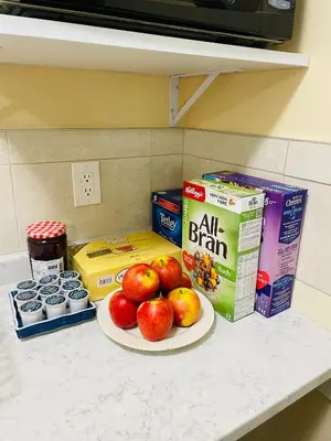 a plate of apples on a counter with cereal and milk at Garden home in Victoria in Victoria
