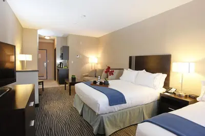 a hotel room with two beds and a television at Holiday Inn Express Fort St John by IHG in Fort Saint John