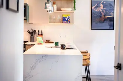 a kitchen with a white counter top in a room at The Shred Shack - Stylish Revelstoke Condo in Revelstoke