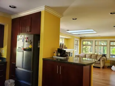 a kitchen with a refrigerator and a counter top at Elegant, Sunny Modern Home with Skylights - Kitsilano, Vancouver in Vancouver