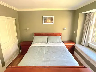 a bedroom with a bed with a wooden head board at Elegant, Sunny Modern Home with Skylights - Kitsilano, Vancouver in Vancouver
