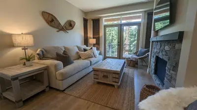 a living room with a couch and a fireplace at Altitude #36 condo in Sun Peaks