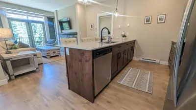 a kitchen with an island in the middle of a room at Altitude #36 condo in Sun Peaks