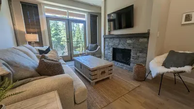 a living room with a couch and a fireplace at Altitude #36 condo in Sun Peaks