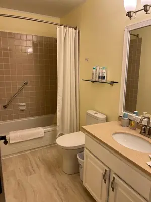 a bathroom with a toilet and a sink and a shower at Bluejay Suites B&B in Whitehorse
