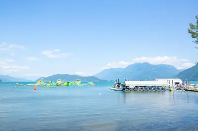 a lake with a group of boats in the water at Wanderlust Studio Suite with Private Patio in Harrison Hot Springs