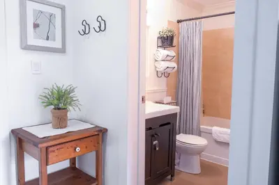 a bathroom with a sink and a toilet and a shower at Wanderlust Studio Suite with Private Patio in Harrison Hot Springs