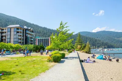 a group of people on a beach near the water at Wanderlust Studio Suite with Private Patio in Harrison Hot Springs