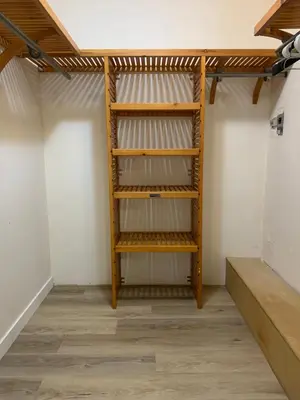 a closet with wooden shelves in a room at Whole Suite to Yourself at Coquitlam Centre! in Port Coquitlam