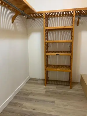 a room with a closet with wooden shelves at Whole Suite to Yourself at Coquitlam Centre! in Port Coquitlam