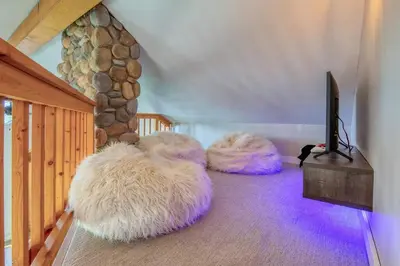 a living room with three furry chairs and a tv at Backyard Oasis Hot Tub, BBQ, Outdoor Bar in Invermere
