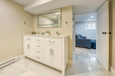 a bathroom with a sink and a mirror at Backyard Oasis Hot Tub, BBQ, Outdoor Bar in Invermere