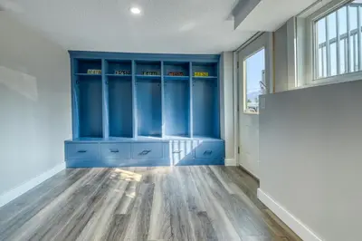a room with blue cabinets and a window at Backyard Oasis Hot Tub, BBQ, Outdoor Bar in Invermere