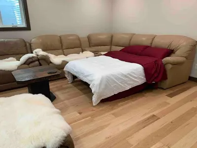 a living room with a couch and a bed at Romantic Luxury Retreat with Private Sauna & Spa, Pet Friendly, Elkside Hideout B&B in Canmore