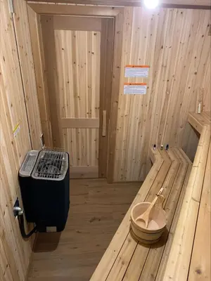 a wooden room with a stove in the middle of it at Romantic Luxury Retreat with Private Sauna & Spa, Pet Friendly, Elkside Hideout B&B in Canmore