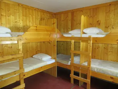 a cabin with four bunk beds in it at HI Rampart Creek - Hostel in Saskatchewan River Crossing