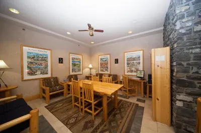 a dining room with a table and chairs at Brewster Mountain Lodge in Banff