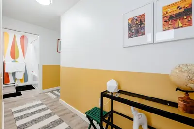 a living room with yellow walls and a cat on a bench at Hidden Gem: Historical Gastown in Vancouver
