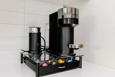 a black coffee machine with colorful eggs on a counter at Hidden Gem: Historical Gastown in Vancouver