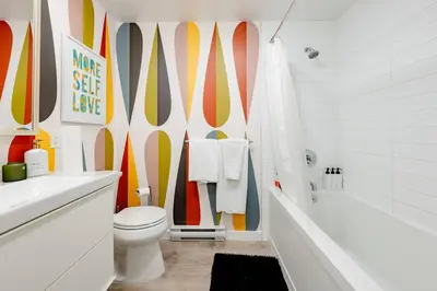 a bathroom with a toilet and surfboards on the wall at Hidden Gem: Historical Gastown in Vancouver