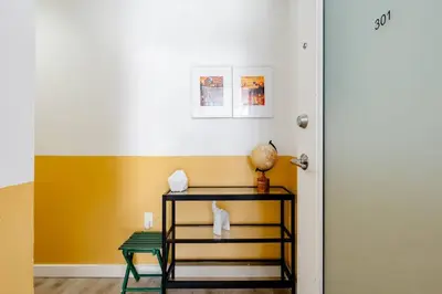 a room with a table and a yellow wall at Hidden Gem: Historical Gastown in Vancouver