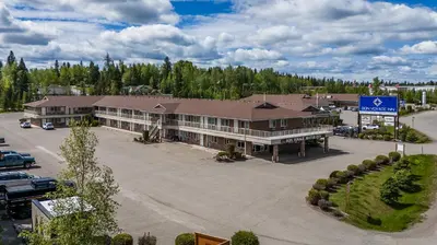 an aerial view of a large building with a parking lot at Bon Voyage Inn in Prince George